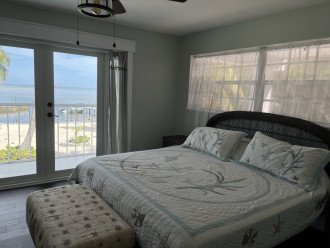 South bedroom with custom closet cabinetry. Open ocean views, access to balcony