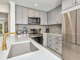 Fully stocked kitchen with granite counter-tops