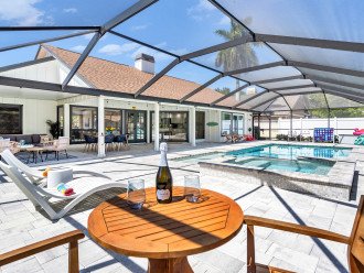 Nearly every room in the home flows out to this incredible outdoor space with a saltwater pool and spa, sunshelf, lounge chairs, outdoor games, and pool floats provided. All enclosed in a huge screened lanai!