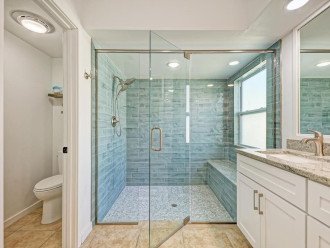 The primary bathroom has a huge walk-in tile shower.