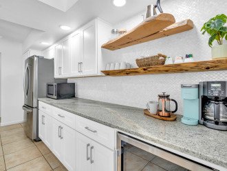 The kitchen includes a backsplash made of real shells, floating driftwood shelves made by a local artist, granite countertops, and all the appliances and accessories you will need.