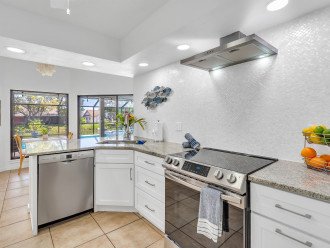 The newly update kitchen includes full-sized appliances, granite countertops and tile backsplash.
