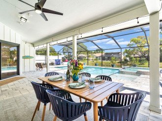 The outdoor dining table is the perfect place to enjoy meals next to the pool!