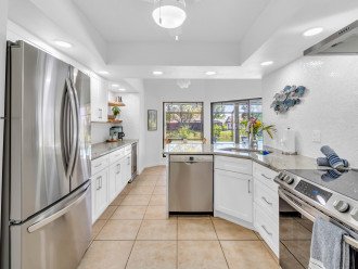 The kitchen has pool views and full-sized appliances.