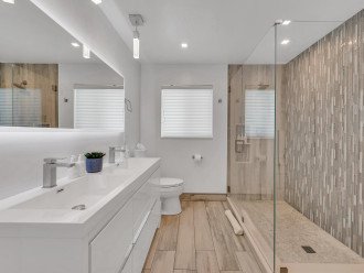 Indulge in a spa-like experience in our guest bathroom, where luxury meets functionality with a stunning walk-in shower and stylish double vanities.
