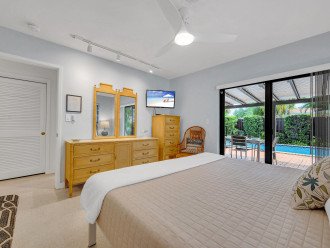 The third bedroom with a king size bed and smart TV boasts a gorgeous view with direct access to the heated pool.