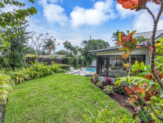 The backyard oasis offers privacy along with extra lawn space for games or gathering in the sun, along with a heated pool, loungers, al fresco dining and grilling area.