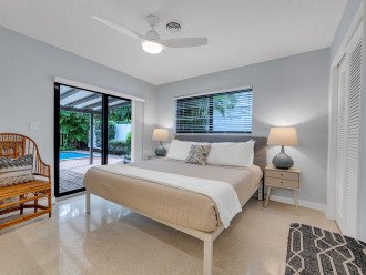 The third bedroom with king size bed, smart TV, and an amazing view with private access to the heated pool, patio and lush surroundings.