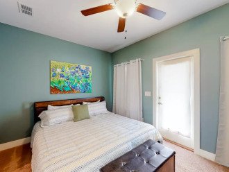 Primary bedroom on second floor with King Size Bed w/built-in USB charging ports, Flat Screen Smart TV, En-Suite Bath with Shower/Tub Combo, Private 2nd floor Covered Balcony