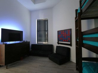 Triple Bunk bedroom with 40" backlit TV, mini Nintendo game console, 3 chairs for relaxing/gaming that also convert into a sleeping mat if needed and an oversized connect 4!