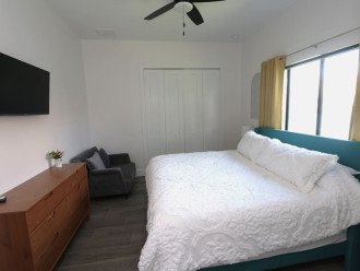 Another view, 2nd King sized bedroom, 40" backlit TV, Touch lamps with USB charging ports, plenty of storage space with the end tables, dresser and luggage racks, walkout to pool area and an oversized chair that converts into a twin bed if needed.