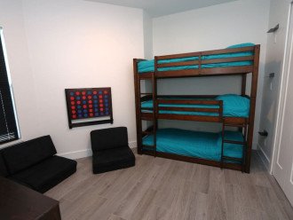 Another view, Triple Bunk bedroom with individual charging outlets and shelves for each bunk, 40" backlit TV, mini Nintendo game console, 3 chairs for relaxing/gaming that also convert into a sleeping mat if needed and an oversized connect 4!