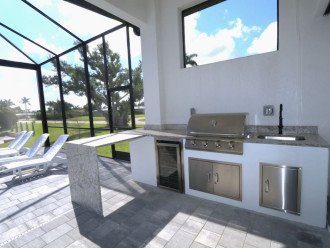 Lanai/outdoor kitchen area with fridge and bar area