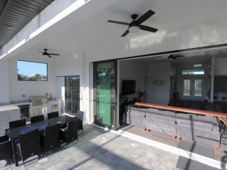 Lanai/outdoor kitchen area with 8 seat patio table