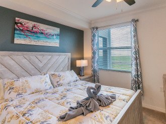 Master bed room with comfy bed and window overlooking golf course and lakeview