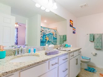 Guest bathroom with dual sinks & shower tub. Entrance from hallway and guest BR