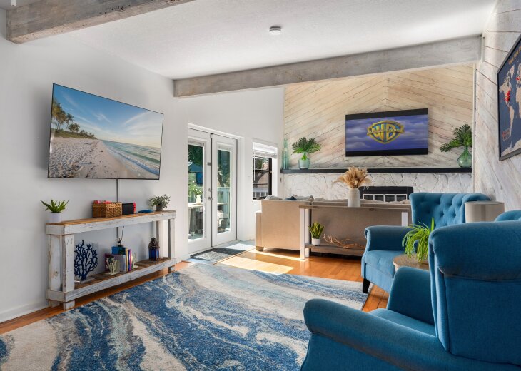 Bright, open living-unwind together after a beach day with 75” & 65" Smart TV.