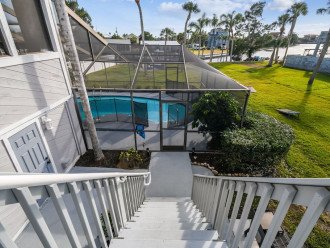 Exterior stairs from primary suite/decks to lanai/pool. Enjoy a late night dip!