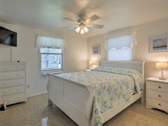 Bright and airy, the second bedroom boasts a plush queen bed.