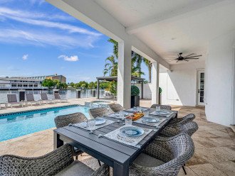 Relish in the waterfront tranquility with canal views from the heated pool, secluded outdoor lounge area by the private dock.