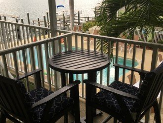 Private bar table & chairs overlooking pool & Boca Ciega Bay