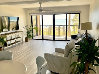 Living area with sliding doors onto patio overlooking beach. Fantastic sunsets!