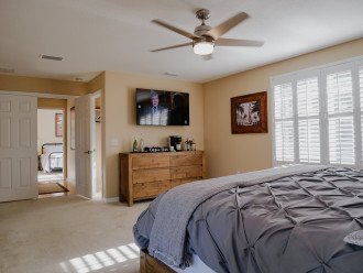 Master bedroom has a large smart tv and coffee bar