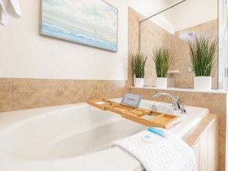 Master bath with walk-in shower and jacuzzi bathtub.