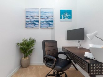 Dedicated workspace off the master bedroom with a printer and monitor.