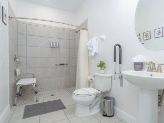 Accessible bathroom downstairs with roll-in shower, shower chair & safety bars.