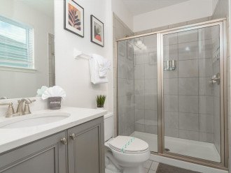 Tranquil private attached bathroom with a single vanity and walk-in shower.