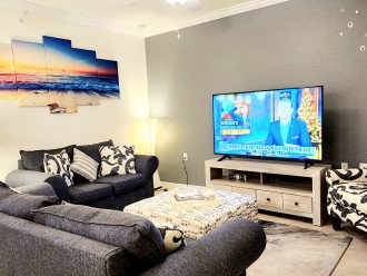 Living room with comfy couch and Smart TV with cable ready