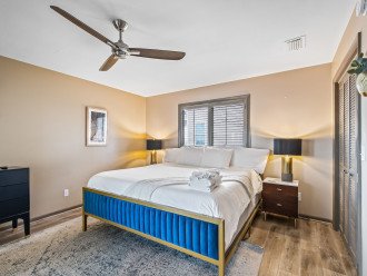 Third king guest bedroom connects to a bathroom and deck.Modern amenities and plenty of storage in this spacious king bedroom. The room is designed for comfort and functionality, featuring ample space for all your needs.