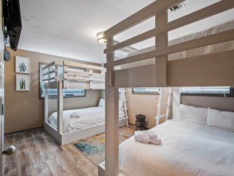 This room features 4 queen beds arranged in 2 bunkbed sets. Perfect for large families, group of friends or guests who want to maximize space while enjoying a good night sleep.
