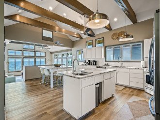Cook and entertain in style in this open-plan kitchen with a large island, top-of-the-line amenities, and a seamless blend with the sitting area. Both areas offer stunning ocean views, making it the space for hosting and savoring coastal living.