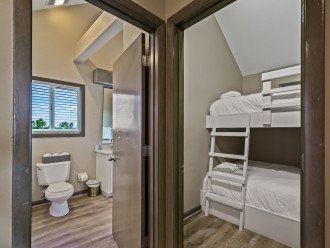 Master bedroom suite on top floor connects to deck and has a bunk room.