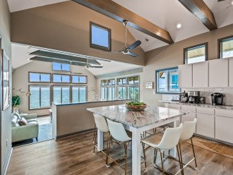 Experience coastal luxury at its finest with this stunning open-concept kitchen and living area. The fully-equipped kitchen boasts gorgeous sea views, while the comfortable seating area provides the perfect spot to take in the spectacular scenery.