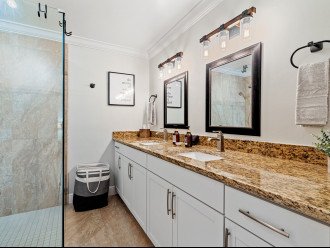 The spacious Tesoro Suite bathroom has double sinks and walk-in shower