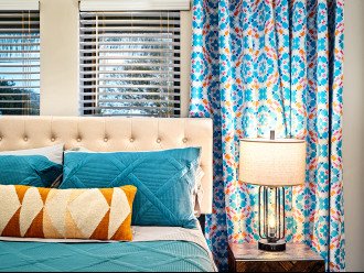 The Boho Room features a queen pillow top mattress, TV, and blackout curtains