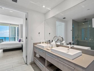The master bathroom features a double vanity, a walk in shower (with shampoo, conditioner and body wash dispensers), and a bathtub.