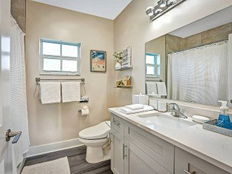 Make your way into the full bathroom found upstairs, with another beautiful, modern interior, a large vanity area and a fully tiled shower bath combo.