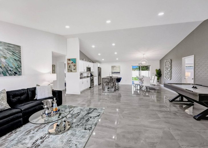 Welcome to your next glamorous newly constructed home! Starting off in the beautiful open plan living room with an air hockey table seamlessly flowing into the dining area and the kitchen underneath vaulted ceilings