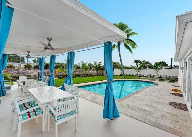 Welcome to your next waterfront tropic oasis! Starting off in the backyard with your very own private pool area, with loungers on the private patio and a large palm tree to add to the scenery
