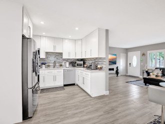 The kitchen is in an open concept layout with the living room which flows around to the air hockey and dining room.