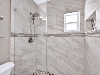 Step on into the ensuite bathroom also accessed from the hallway, with a stunning fully tiled walk in shower. The perfect place to let the water wash away all your stresses of the modern day hustle and bustle.