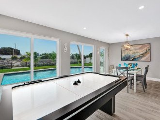 Play air hockey, splash in the pool, chill out on the sun loungers, cook up a BBQ… endless things to do! The dining and air hockey room has beautiful pool and canal views through the large glass sliding doors.
