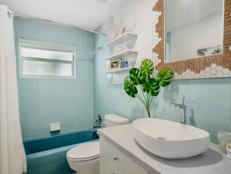 Bathroom has restored 1960's vintage aqua blue tiles