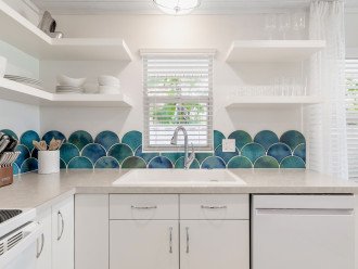 Watercolored handmade, hand glazed clay tiles are the focal point of the kitchen.
