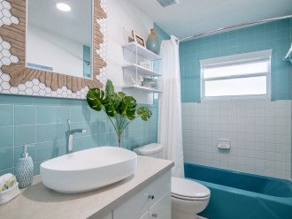Bathroom has restored 1960's vintage aqua blue tiles.
