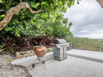 Charcoal and gas BBQ grills on patio with gulf water views